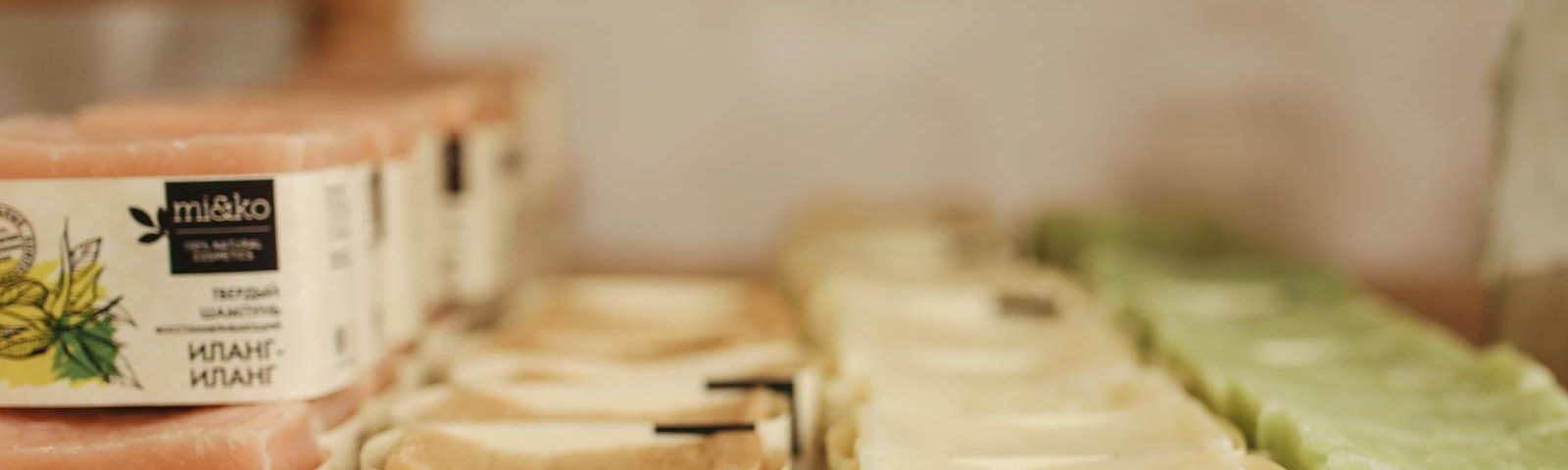 A selection of natural skincare products, including soaps, is neatly organized indoors for sale.