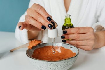 Close-up of spa treatment using clay mask and essential oil.