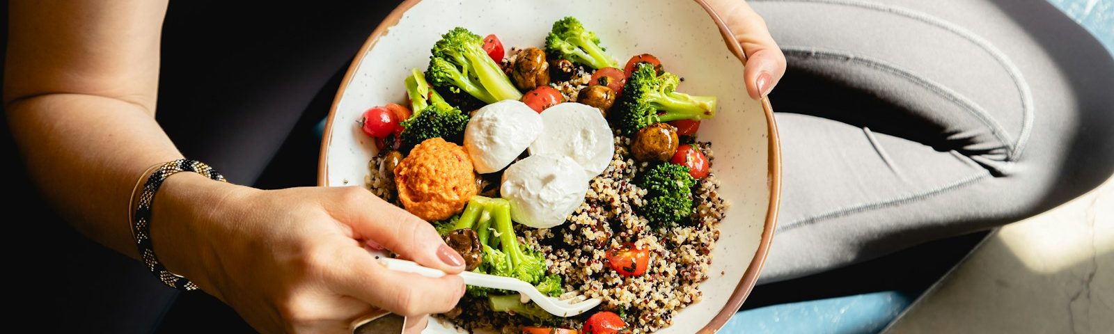 a woman is holding a bowl of food