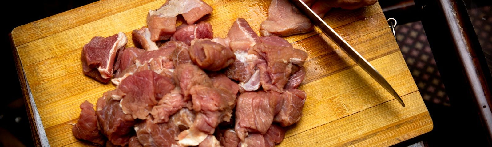 sliced meat on brown wooden chopping board